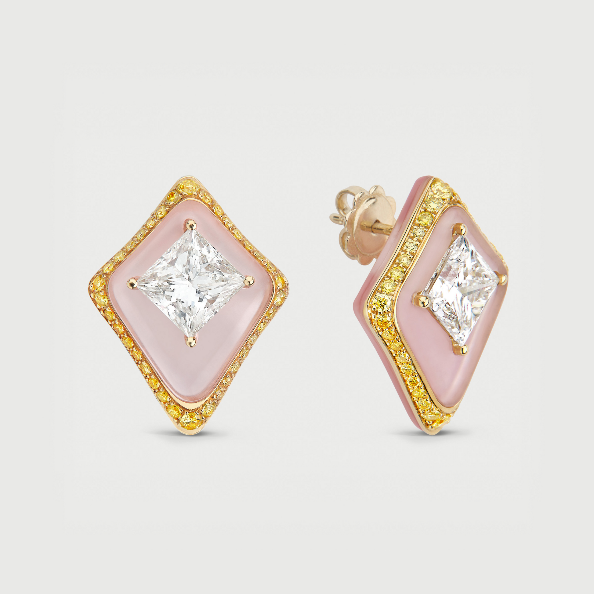 Pair of earrings with pink and gold design on a light gray background