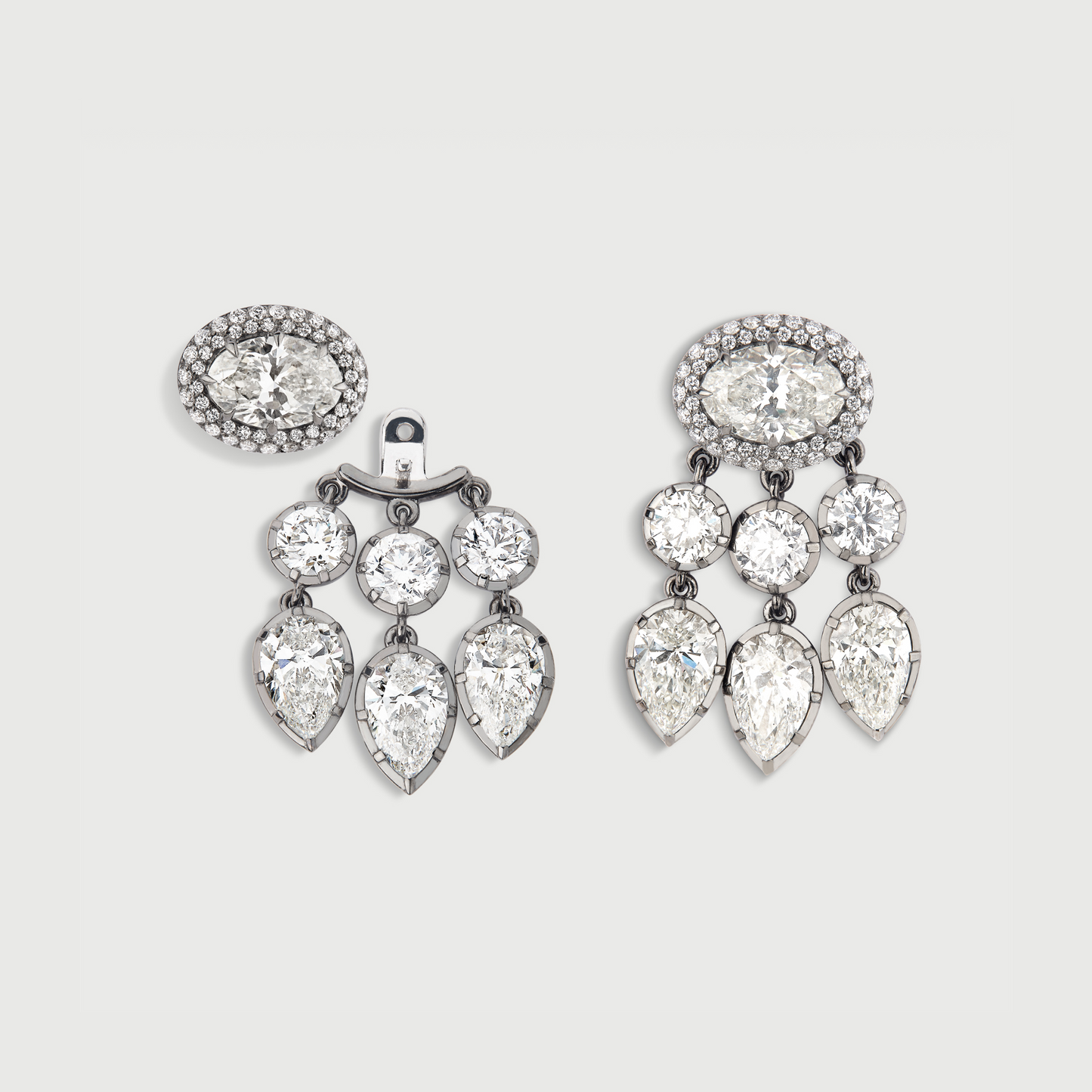 Pair of chandelier earrings with clear gemstones on a light gray background
