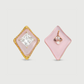 Pair of earrings with pink square stones and gold accents on a light gray background