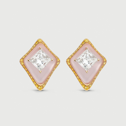 Pair of diamond-shaped earrings with pink centers and gold frames on a light gray background
