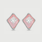 Diamond earrings with pink gemstones on a light gray background