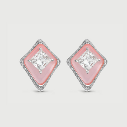 Diamond earrings with pink gemstones on a light gray background
