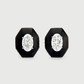 Pair of black stud earrings with clear gemstones on a light gray background