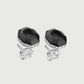 Pair of black and silver earrings on a light gray background