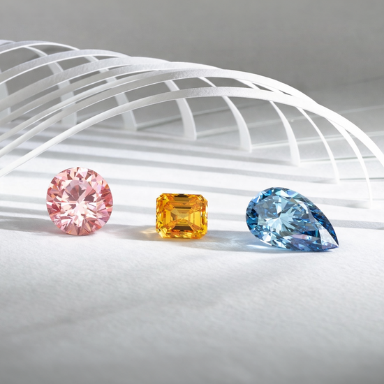 Three colorful diamonds on a white surface with a geometric background