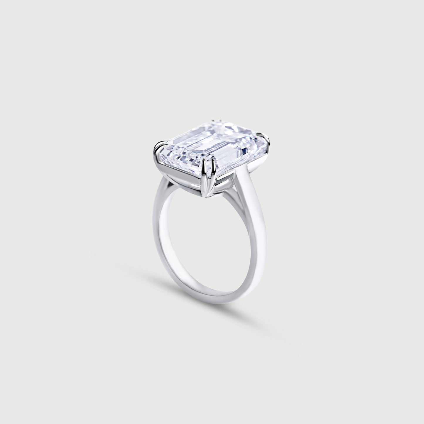 White gold ring with a large rectangular diamond on a light gray background