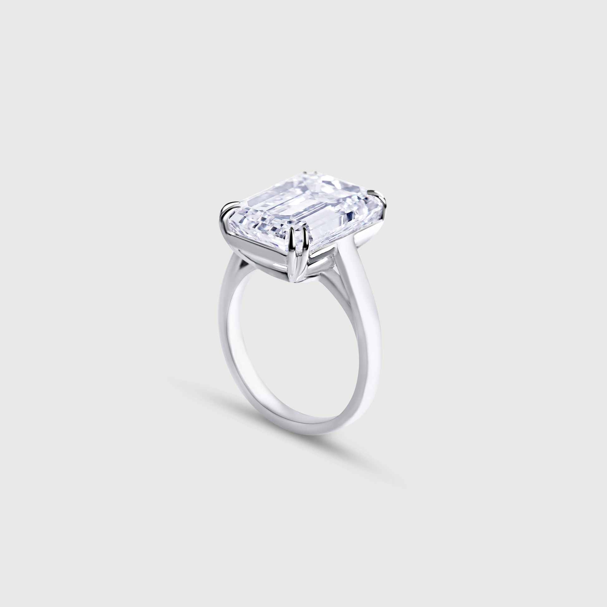 White gold ring with a large rectangular diamond on a light gray background