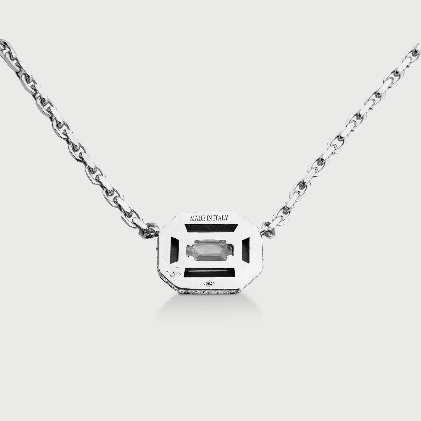 Silver necklace with a rectangular gemstone pendant on a white background