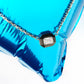 Diamond necklace on a blue metallic surface